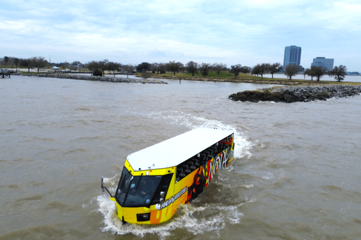 a train traveling down tracks next to a body of water