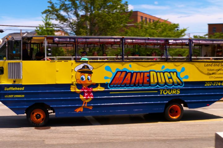 a blue bus parked on the side of a road